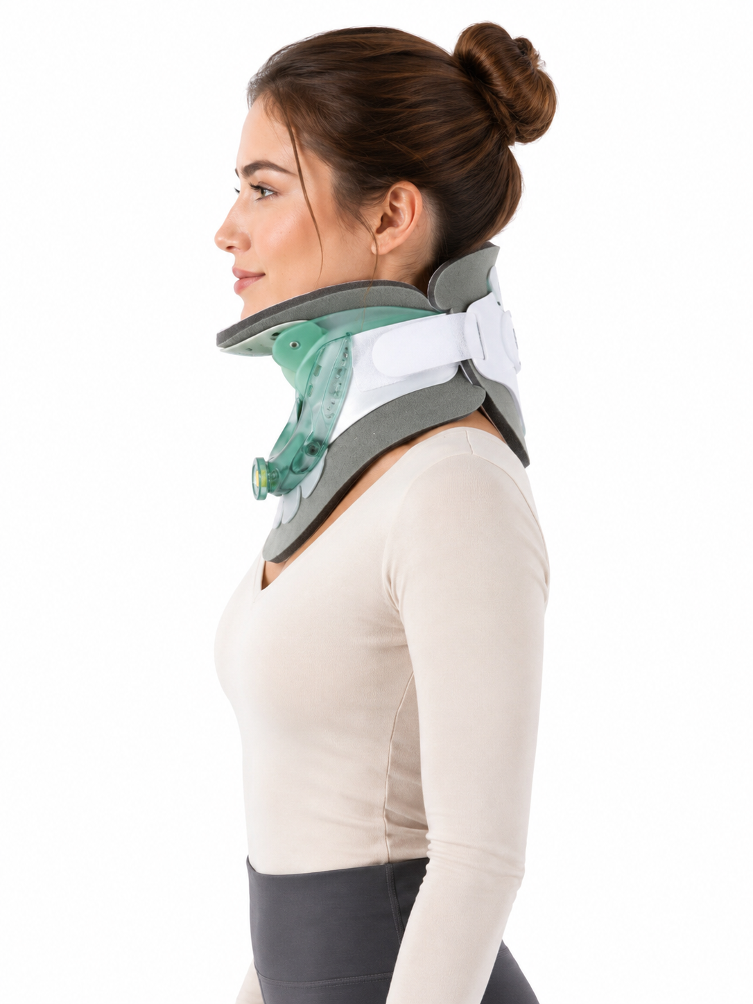 A woman in profile wearing a gray and white cervical collar with a translucent green neck portion, shown against a plain white background.